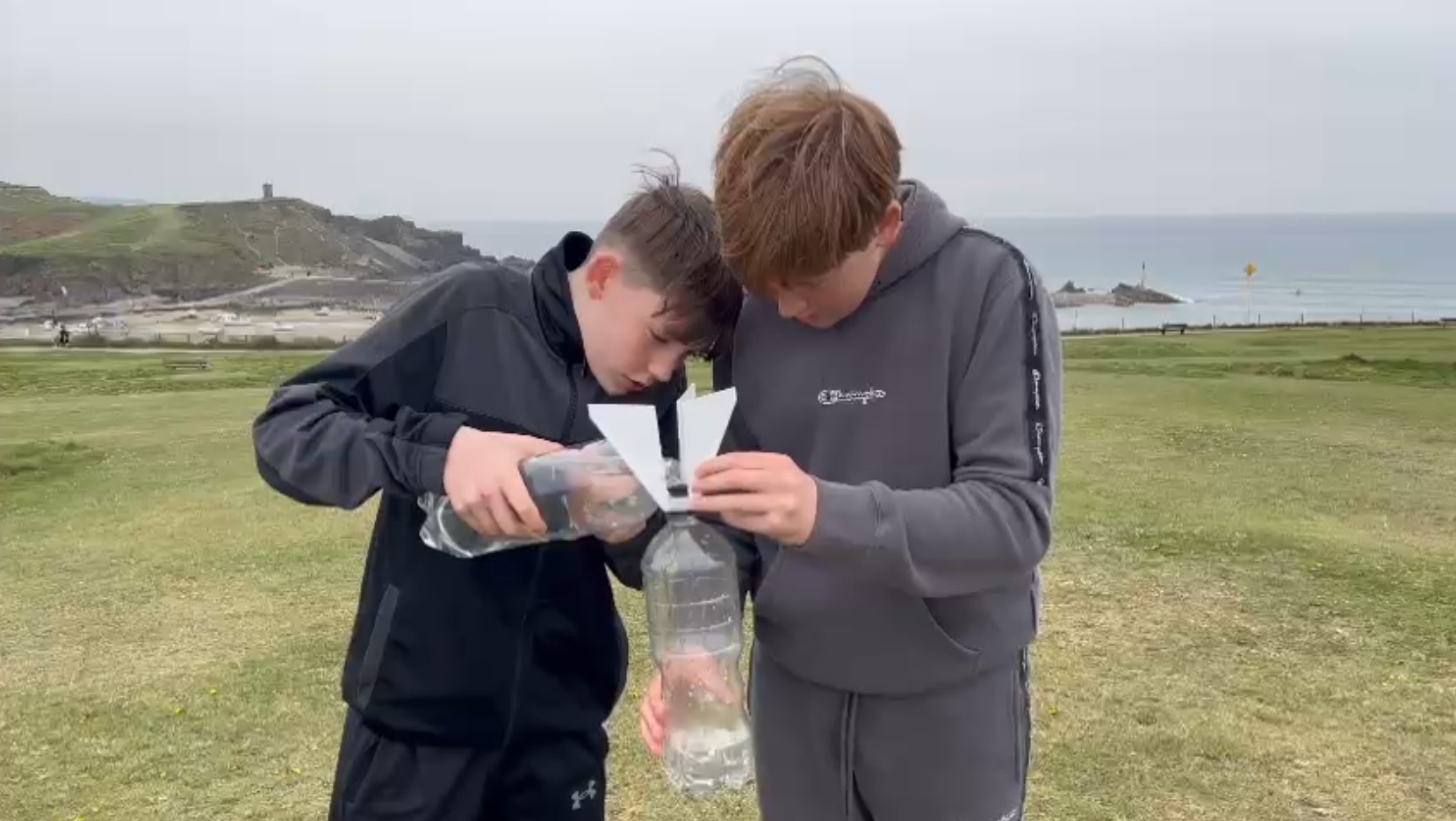 Oscar and Friend Filling Water Rocket by the sea